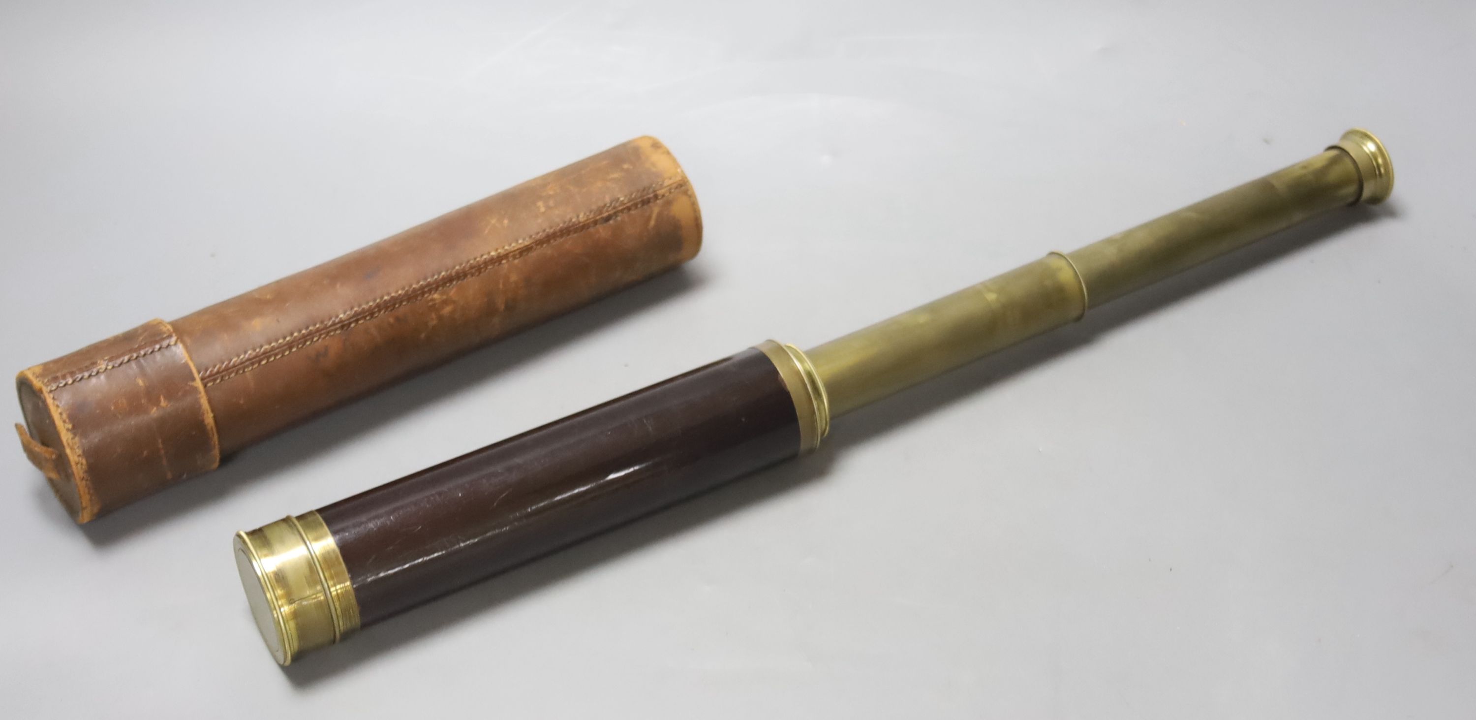 An early 20th century three drawer telescope by Lennie, Edinburgh, in leather case, and a cased slide rule